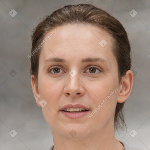 Joyful white adult female with short  brown hair and brown eyes