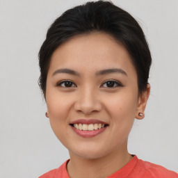 Joyful asian young-adult female with short  brown hair and brown eyes