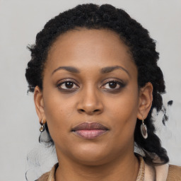 Joyful black young-adult female with long  brown hair and brown eyes