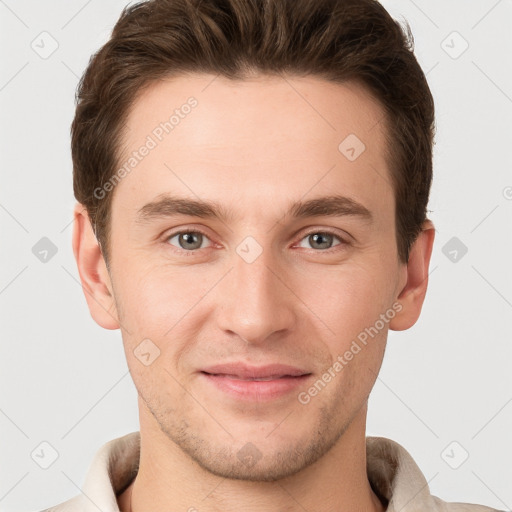 Joyful white young-adult male with short  brown hair and grey eyes