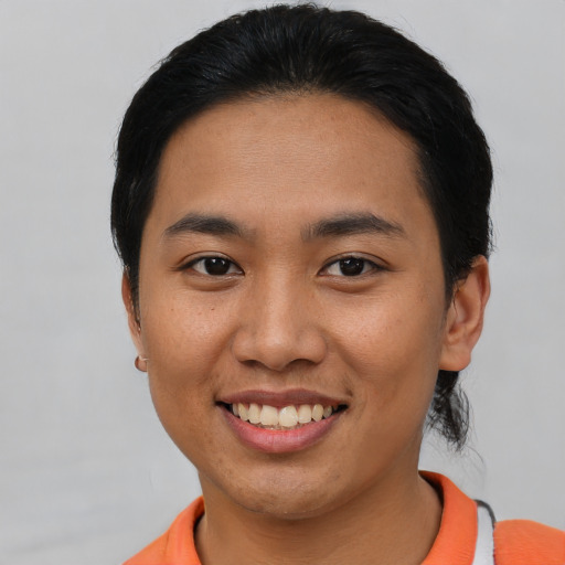 Joyful asian young-adult female with short  black hair and brown eyes