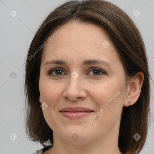 Joyful white adult female with medium  brown hair and grey eyes