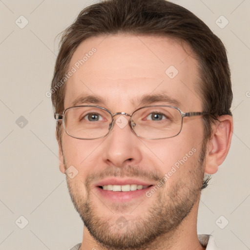 Joyful white adult male with short  brown hair and grey eyes