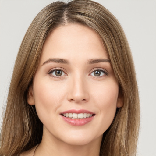 Joyful white young-adult female with long  brown hair and green eyes