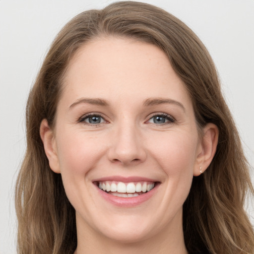 Joyful white young-adult female with long  brown hair and grey eyes