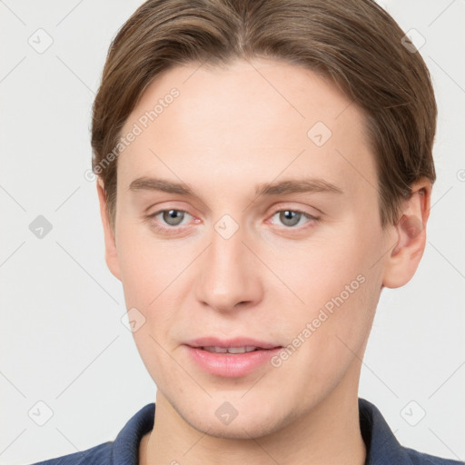 Joyful white young-adult male with short  brown hair and grey eyes