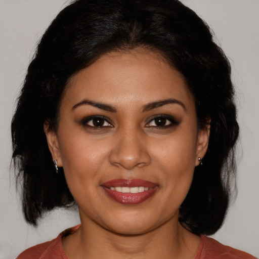 Joyful latino young-adult female with medium  black hair and brown eyes