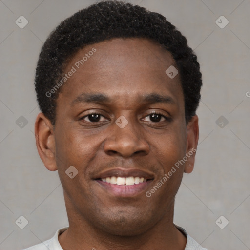 Joyful black young-adult male with short  brown hair and brown eyes