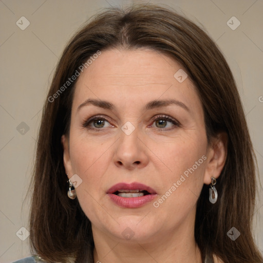 Joyful white adult female with long  brown hair and brown eyes