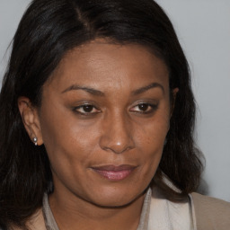 Joyful black adult female with medium  brown hair and brown eyes