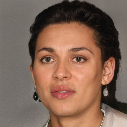 Joyful latino adult female with short  brown hair and brown eyes