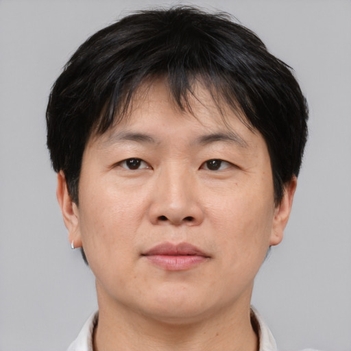 Neutral asian adult male with short  brown hair and brown eyes