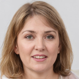 Joyful white young-adult female with medium  brown hair and green eyes