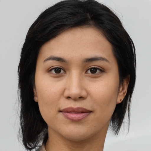 Joyful asian young-adult female with medium  brown hair and brown eyes
