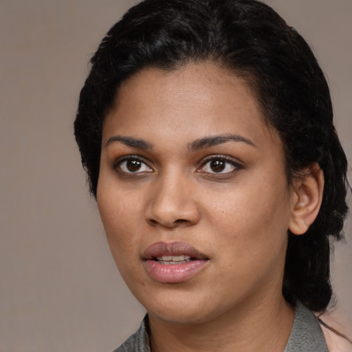 Joyful latino young-adult female with medium  black hair and brown eyes