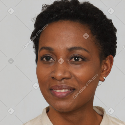 Joyful black young-adult female with short  black hair and brown eyes