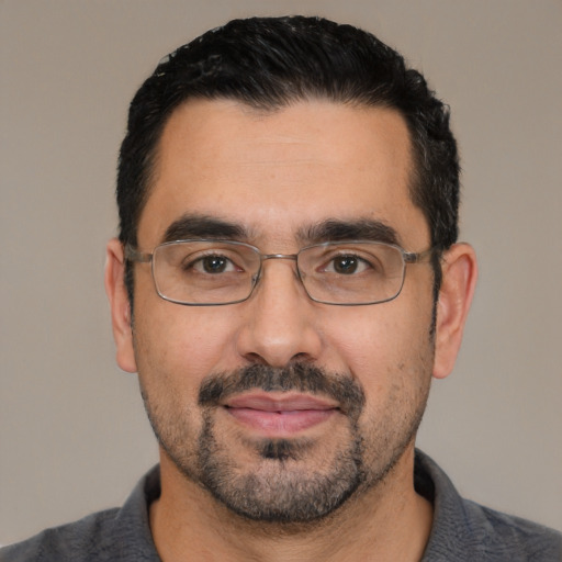Joyful white adult male with short  black hair and brown eyes