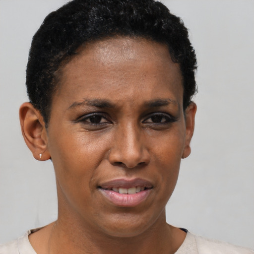 Joyful black adult female with short  brown hair and brown eyes