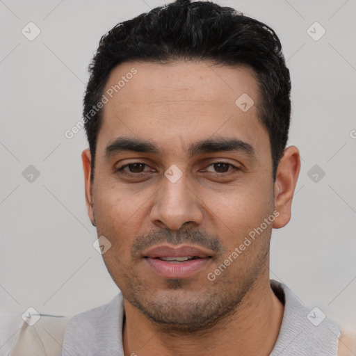 Joyful white young-adult male with short  black hair and brown eyes