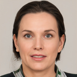 Joyful white adult female with medium  brown hair and grey eyes