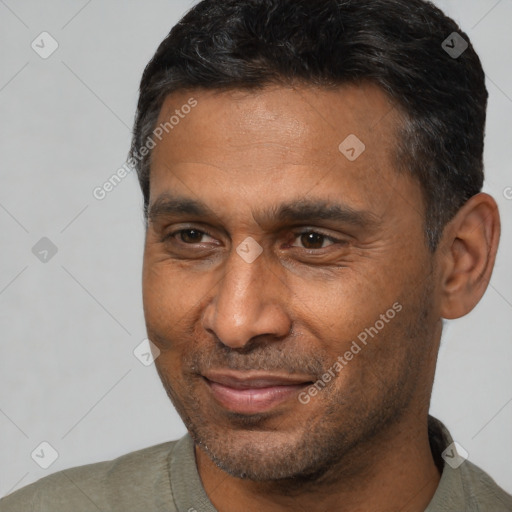 Joyful white adult male with short  black hair and brown eyes