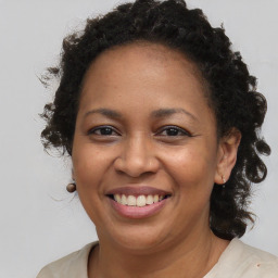 Joyful black adult female with long  brown hair and brown eyes