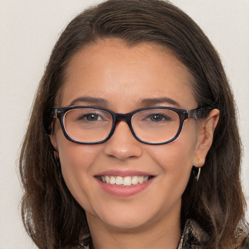 Joyful white young-adult female with long  brown hair and brown eyes