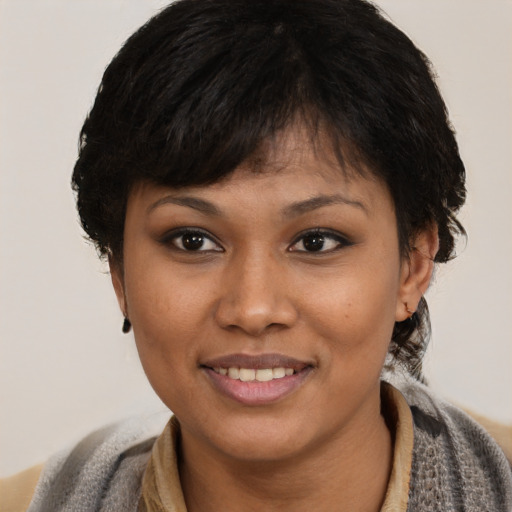 Joyful black young-adult female with short  brown hair and brown eyes