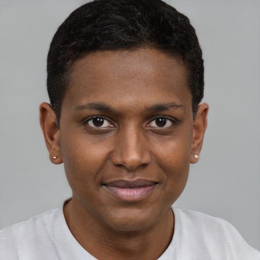 Joyful black young-adult male with short  brown hair and brown eyes