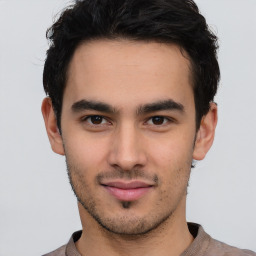 Joyful latino young-adult male with short  brown hair and brown eyes