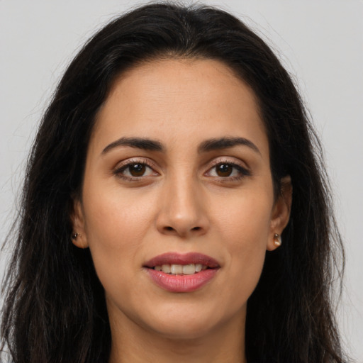 Joyful latino young-adult female with long  brown hair and brown eyes