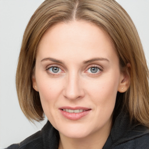 Joyful white young-adult female with medium  brown hair and blue eyes