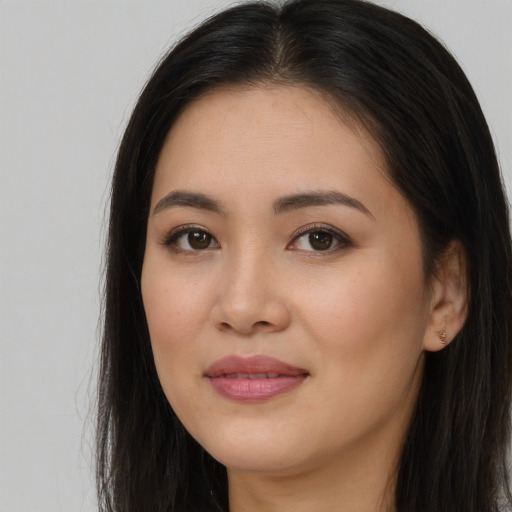 Joyful asian young-adult female with long  brown hair and brown eyes