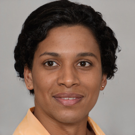 Joyful latino adult female with short  brown hair and brown eyes