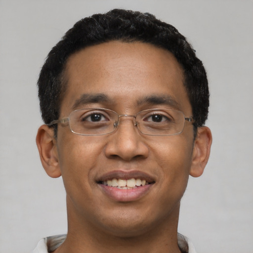 Joyful latino young-adult male with short  black hair and brown eyes