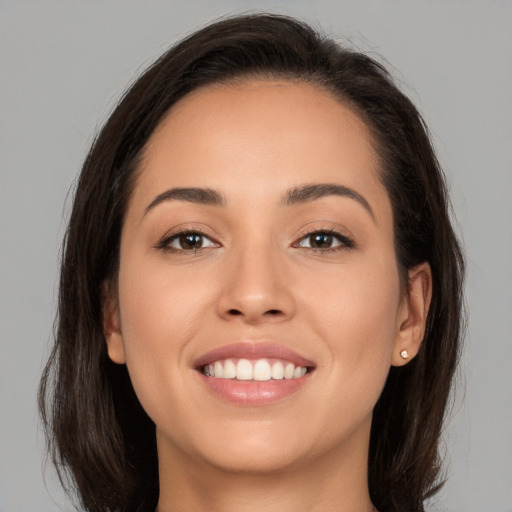 Joyful white young-adult female with long  brown hair and brown eyes