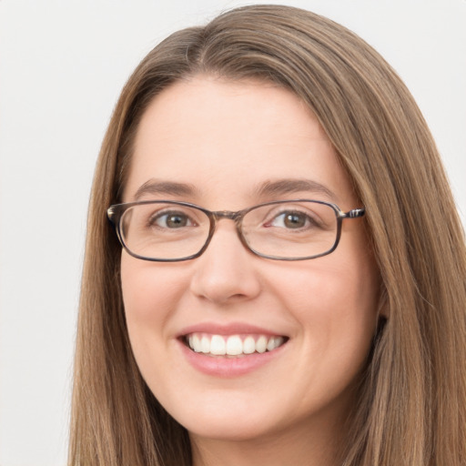 Joyful white young-adult female with long  brown hair and green eyes