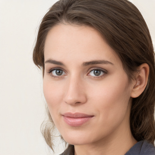 Joyful white young-adult female with medium  brown hair and grey eyes