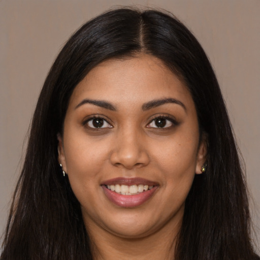 Joyful latino young-adult female with long  brown hair and brown eyes