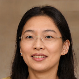 Joyful white adult female with long  brown hair and brown eyes