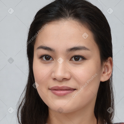 Joyful asian young-adult female with long  brown hair and brown eyes