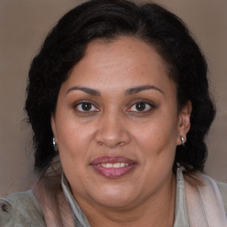 Joyful latino adult female with medium  brown hair and brown eyes