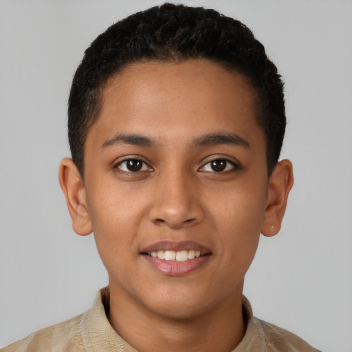 Joyful latino young-adult male with short  brown hair and brown eyes