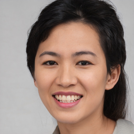 Joyful asian young-adult female with medium  black hair and brown eyes