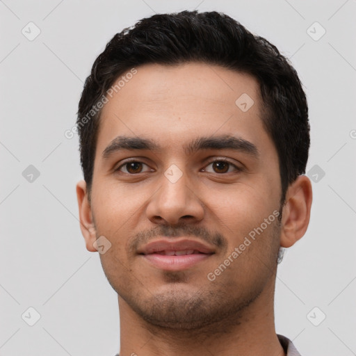 Joyful latino young-adult male with short  black hair and brown eyes