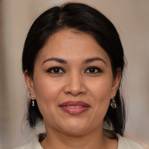 Joyful white adult female with medium  brown hair and brown eyes