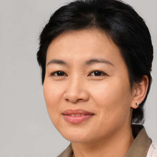 Joyful asian young-adult female with short  brown hair and brown eyes