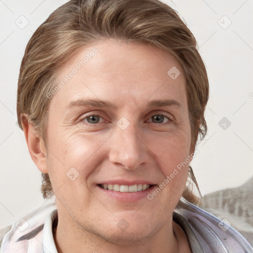 Joyful white adult female with short  brown hair and grey eyes