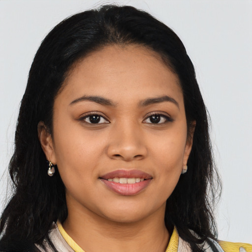 Joyful latino young-adult female with long  black hair and brown eyes