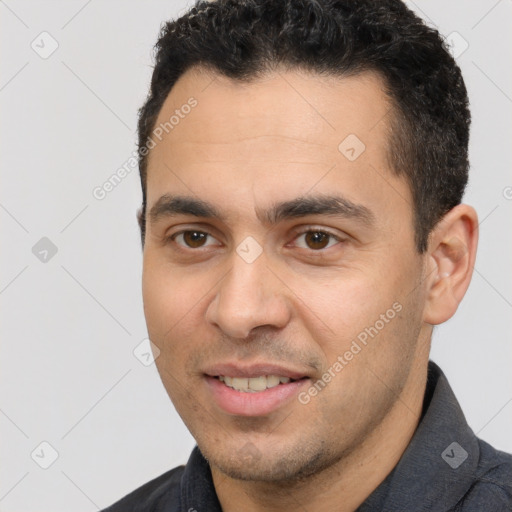 Joyful white young-adult male with short  black hair and brown eyes